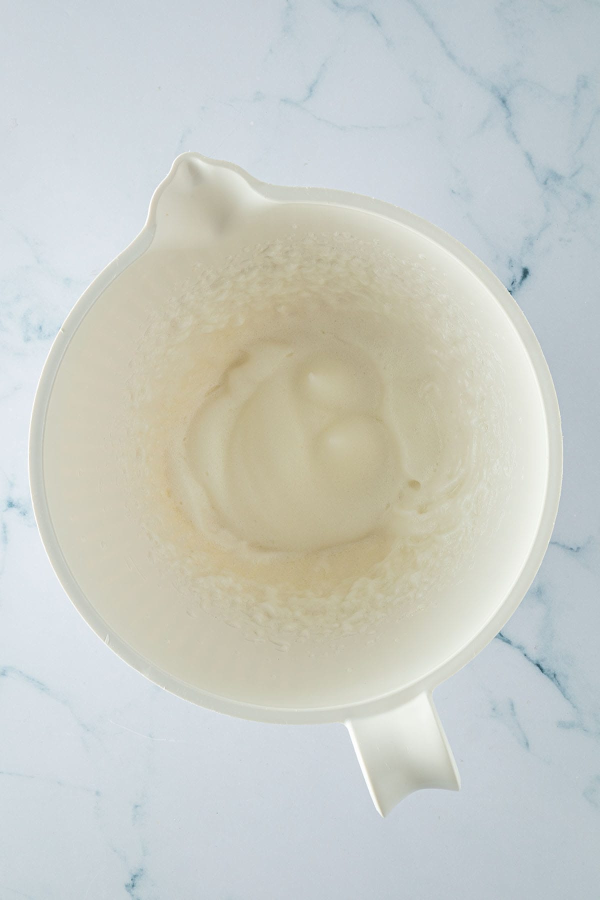 Steif geschlagener Eischnee in einer weißen Rührschüssel.